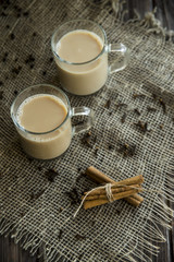 Masala tea with milk and spices - cinnamon, cloves, pepper, cardamom and ginger