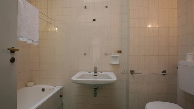 Old bathroom interior with artificial light, nobody