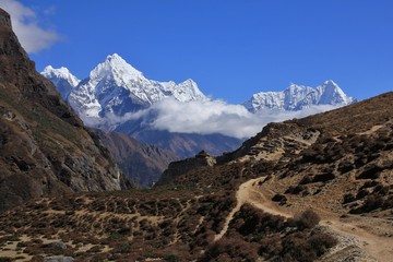 Trekking trail in the Thame valley, Everest National Park, Nepal. Mount Thamserku and Khusum Kangaru.