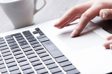 Businesswoman navigating on a laptop computer
