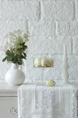 white drawer cabinet and vase of flower home and room objects