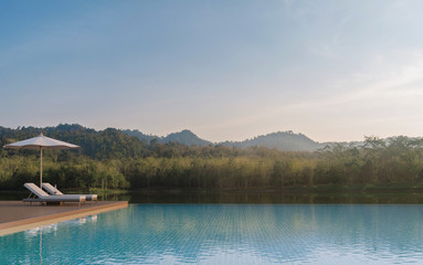Swimming pool terrace and beautiful nature view 3d rendering image,A place surrounded by nature ,There are wood floor and blue tile