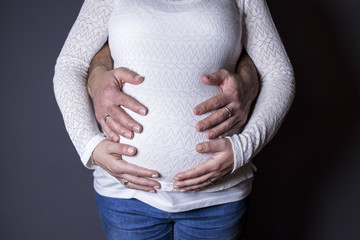 belly of a pregnant woman with father