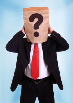 Man with a paper bag on head with question mark