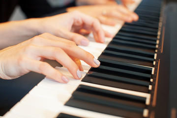 Obraz premium Closeup of hands playing piano. Music and hobby concept