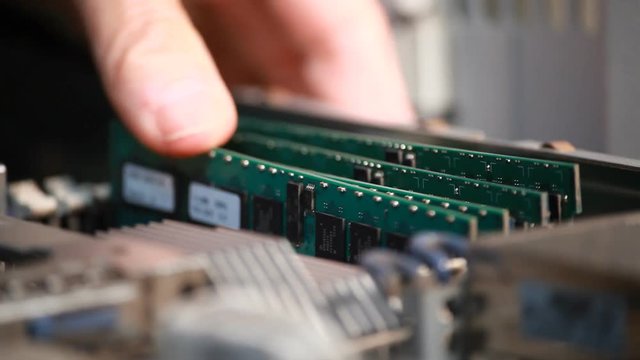 Technician replacing ram chips in a corporate server.