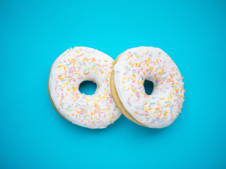 Donuts glazed with sprinkles on a blue background