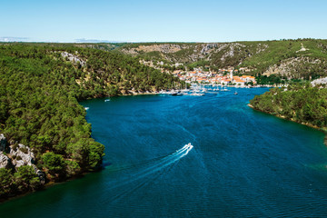 Town of Skradin on Krka river in Dalmatia, Croatia viewed from distance. Skradin is a small historic town and harbour