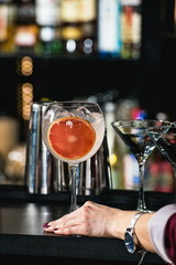 woman holding refreshing ruby red coctail with grape fruit isola