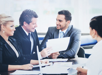 Fototapeta premium Image of business partners discussing documents and ideas at meeting