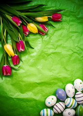 Eastern egg, tulips on green crumpled wrapping paper