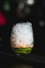 refreshing coctail with cucumber isolated on a bar background