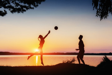 couple in play at sunset by the lake