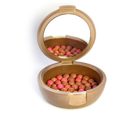 cosmetic powder in a box with a mirror on a white background