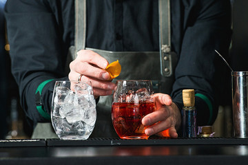 bartender making relaxing coctail on a bar background