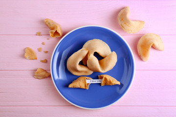 Plate with fortune cookies  on wooden background