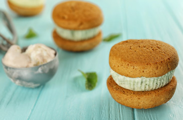 Ice cream cookie sandwiches with fresh mint on blue wooden background