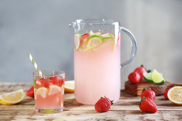 Fresh strawberry water in glassware on grey background