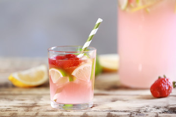 Fresh strawberry water in glass on grey background