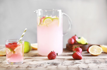 Fresh strawberry water in glassware on grey background
