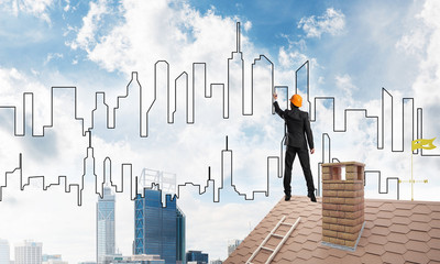 Man architect draw silhouette of modern city on blue sky. Mixed media