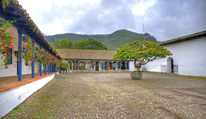 Central plaza of an old colonial hacienda, with a tree in the center. Outskirts of Ibarra city,...