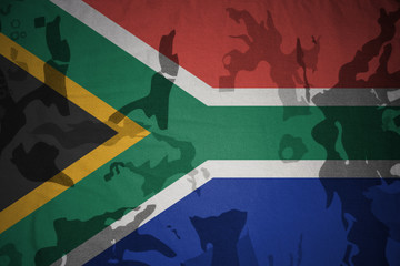 flag of south africa on the khaki texture . military concept