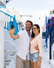 Young couple taking selfie in Mykonos