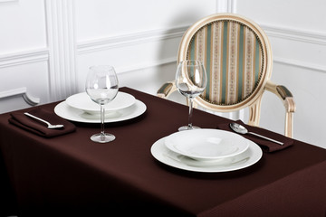 Beautiful decorated table with linen napkins, cutlery on luxurious tablecloth
