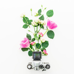 Old Camera and flowers isolated on white background. Flat lay, Top view