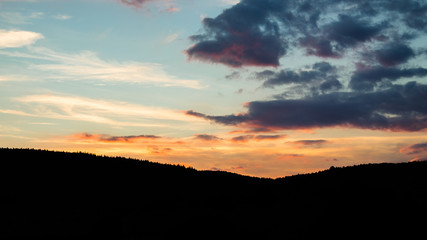 Sunset in the mountains, colorful cloudy sky