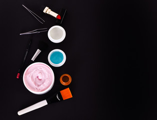 various cosmetics: cream, gel, lipstick, lip liner, brushes and tweezers