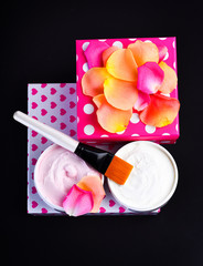 various cosmetics: cream, brush and box with rose petals