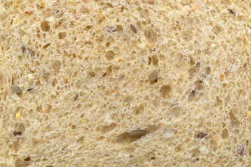 A very close view of a nine grain bread slice.