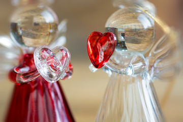Crystal glass angel with red heart in the hands. Happy Valentine's Day text 