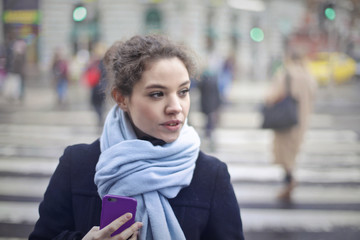 Girl with phone in the city 