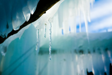 Fototapeta na wymiar Warm pleasant icicles background with warm light reflections