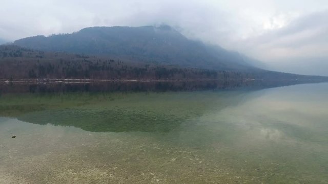 4K. Amazing Bohinj Lake in foggy weather, panoramic view. Julian Alps, Triglav National Park, Slovenia, Europe. Winter time.