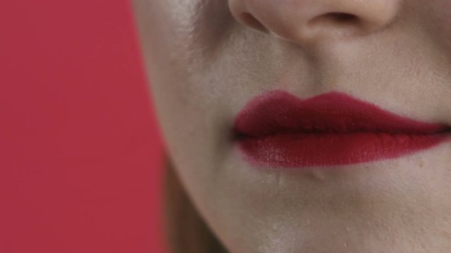 girl paints her lips close-up