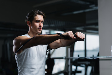 Turn up the intensity. Young man working out with a resistance band in gym