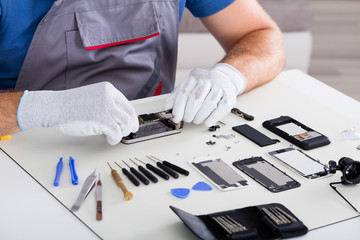 Person's Hand Repairing Cellphone