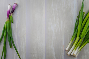 Scallions Surround Copy Area on Wooden Background