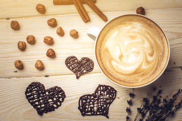 Flavored coffee cappuccino with chocolate in the shape of heart.