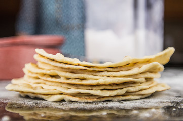 Stack of Flour Tortillas with Flour Bin in Background