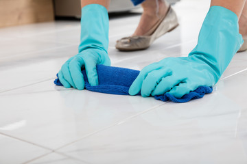 Person Cleaning Floor With Cloth