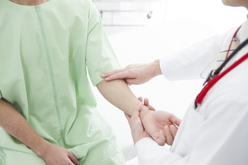 The doctor is confirming the patient's pulse