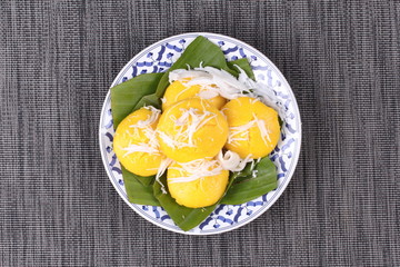 Toddy palm cake topped roll coconut .