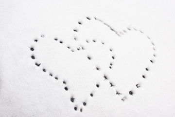 Shapes of heart on snow