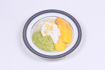 Ripe golden mango with green and white of sticky rice.