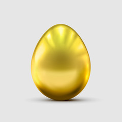 Golden egg isolated on gray background